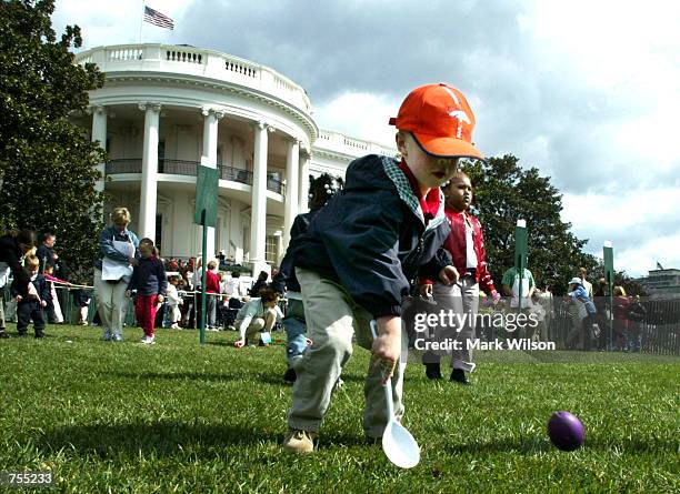 Jason Meyer from Arlington Va. Rolls an egg during the annual White House Easter Egg Roll on the South Lawn of the White House April 1, 2002 in...