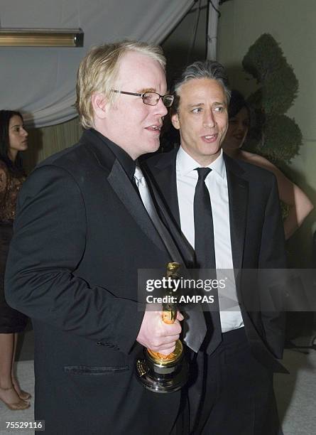 Best Actor Academy Award winner Philip Seymour Hoffman and Academy Awards host Jon Stewart arrive at the Governors Ball after the 78th Annual Academy...