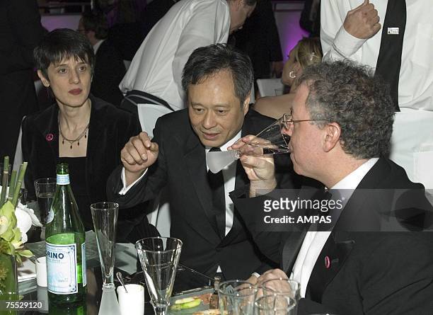 Best Director Ang Lee with producer James Schamus and Schamus' wife Nancy Kricorian at the Governors Ball after the 78th Annual Academy Awards at the...