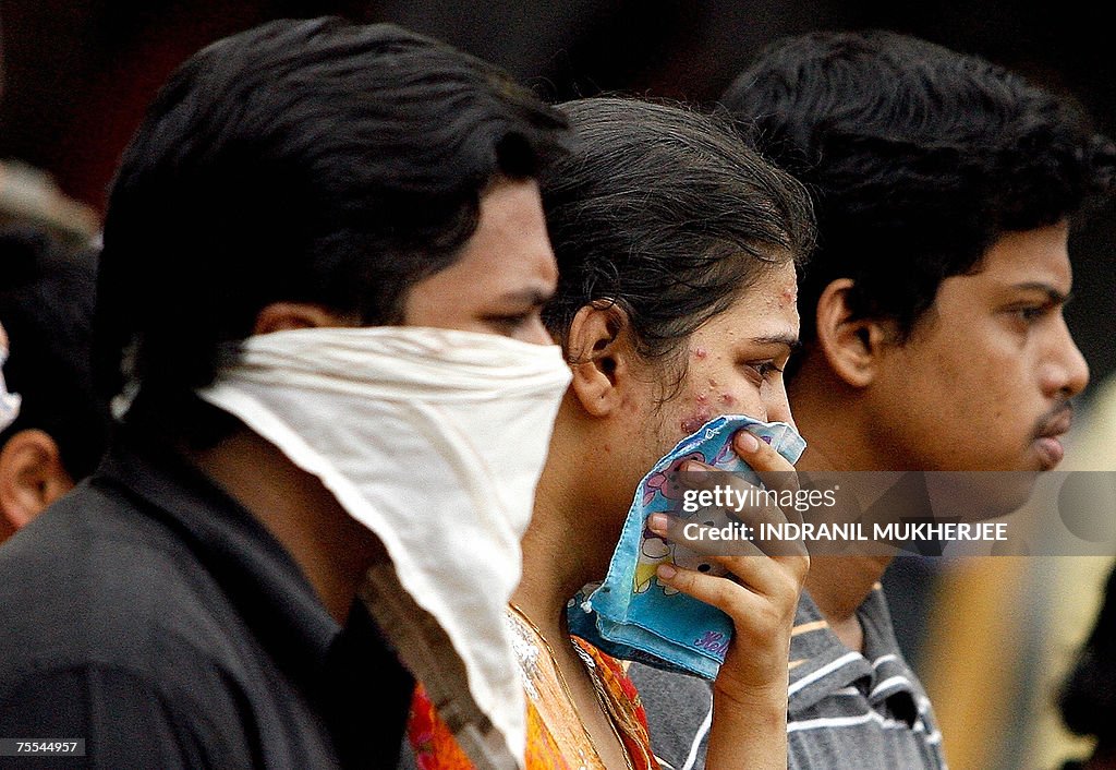 An unidentified Indian woman (C) breaks...
