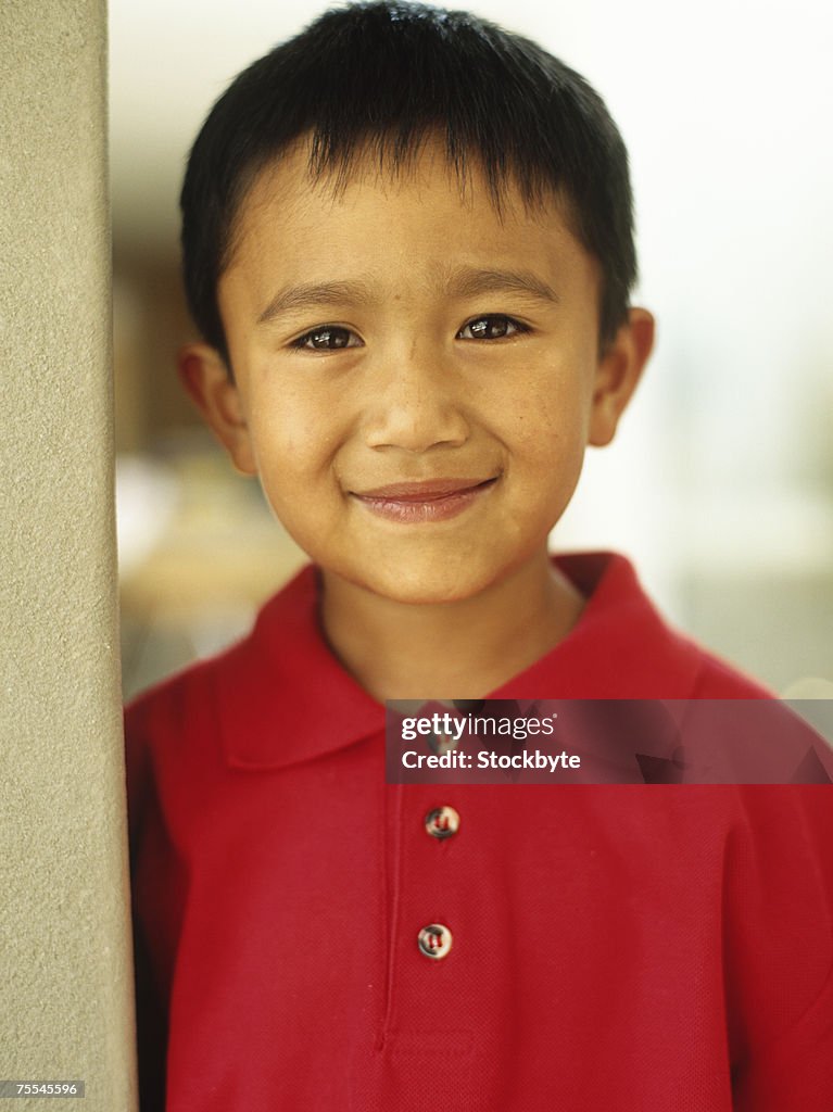 Boy (6-7) smiling,portrait,close-up
