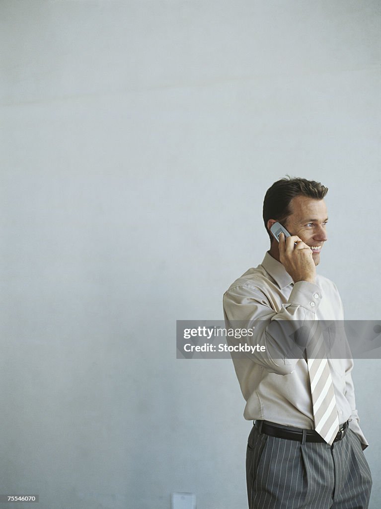 Businessman talking on mobile phone,smiling