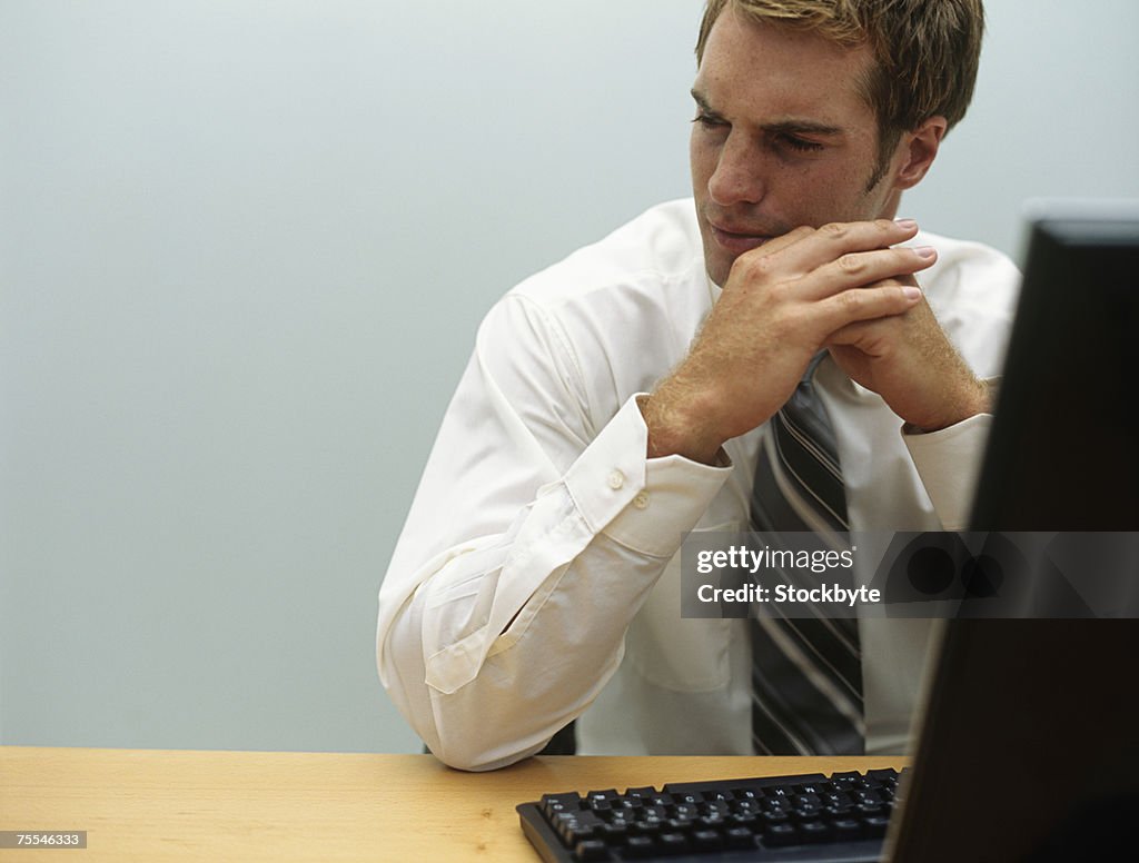 Man working on computer in office,upper half