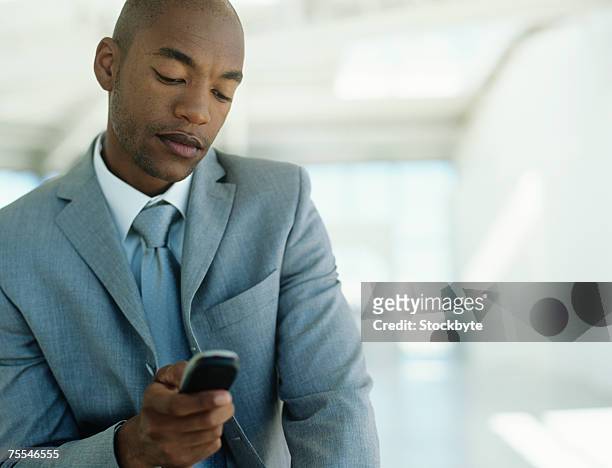 businessman using mobile phone,upper half - half shaved hair stockfoto's en -beelden