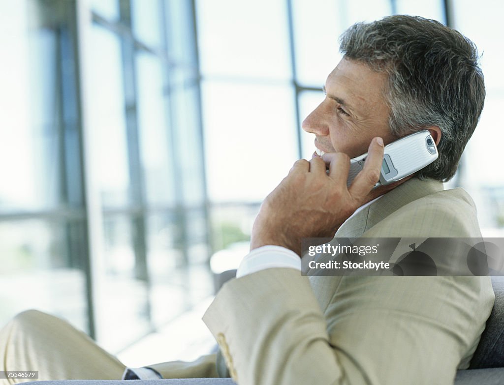 Businessman using mobile phone,profile