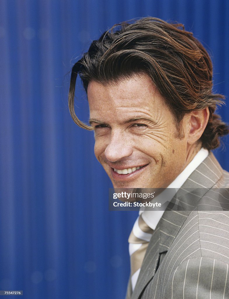 Close-up of mid-adult business man,smiling,cargo container in background