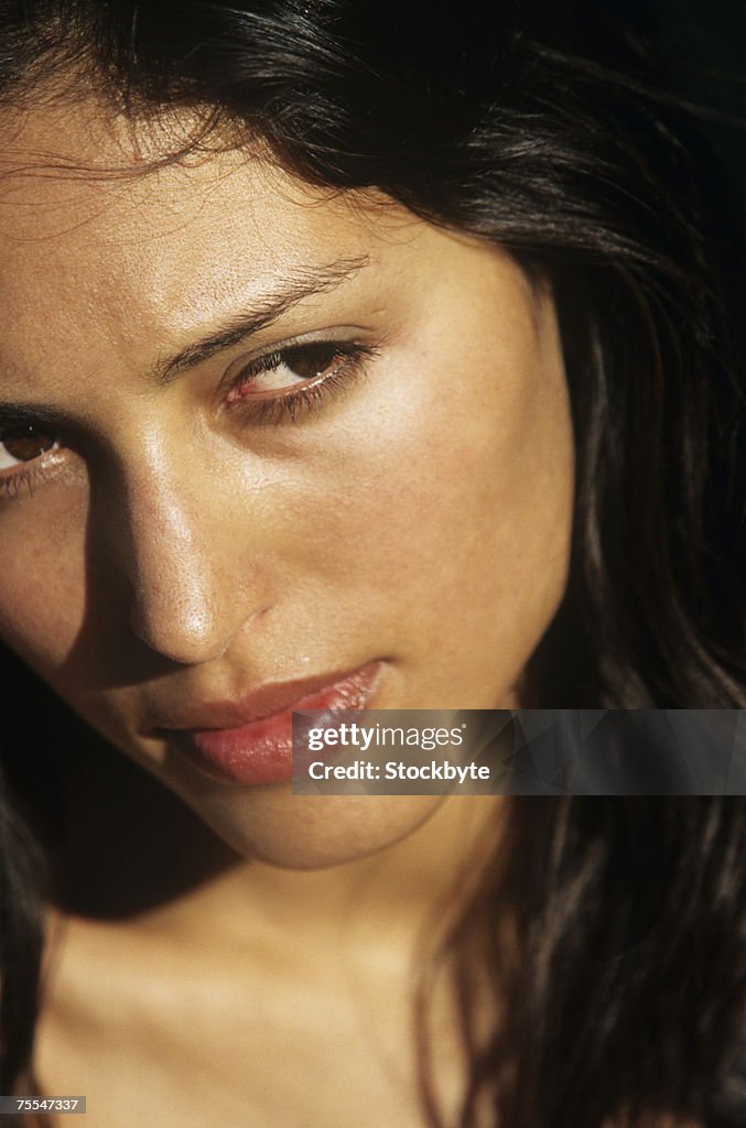 Young woman looking away,close-up of face