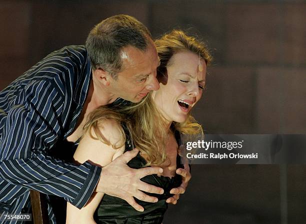 Actor Roland Renner , playing the part of Gunther and Annika Pages, playing the part of Bruenhild perform on stage during the rehearsal of "Die...