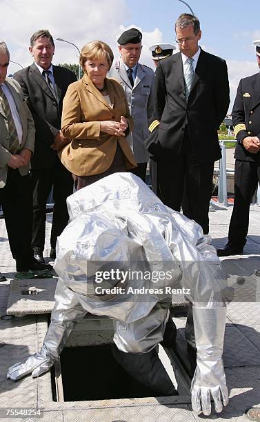 German Chancellor Angela Merkel and Bundestag Military Ombudsman, Reinhold Robbe attend a fire alarm drill at the minesweeper Gefion on July 19, 2007...