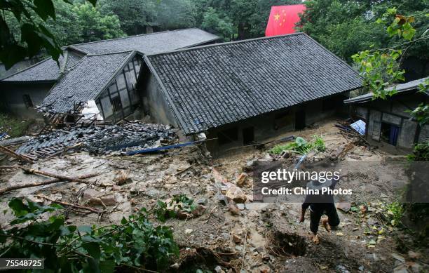 Worker walks past buildings destroyed by mudflows at the memorial site of Zhazidong Prison on July 19, 2007 in Chongqing Municipality, China....