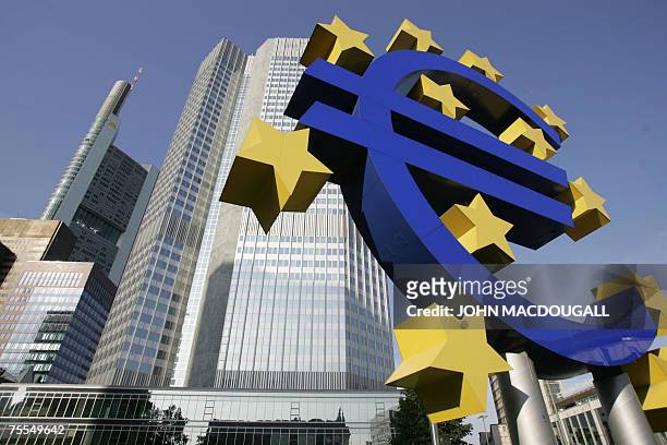 Picture taken 28 June 2005 shows a giant Euro symbol, the currency of the EU, standing in front of Frankfurt's Eurotower, which houses the European...