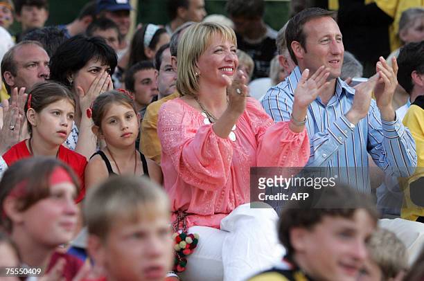Canadian Foreign Minister Peter MacKay and Ukrain's First Lady Kateryna Yushchenko applaud during a concert at the children camp of Vorohta, near the...