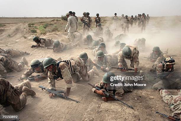 Iraqi army cadettes crawl during a physical endurance test as part of commando training July 19, 2007 at a base near Baqouba, Iraq. The soldiers are...