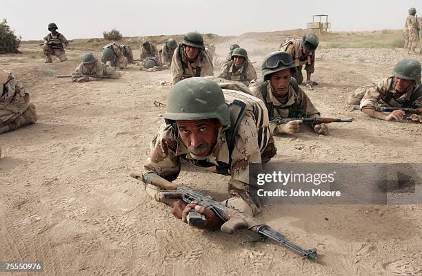 Iraqi army cadettes crawl during a physical endurance test as part of commando training July 19, 2007 at a base near Baqouba, Iraq. The soldiers are...