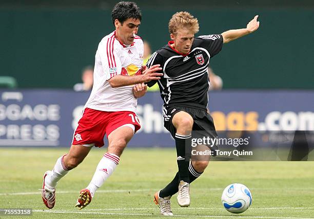 Brian Carroll shields the ball from Claudio Reyna. DC United trounced the New York Redbulls 4-1 behind a Ben Olsen hat trick at RFK stadium in...