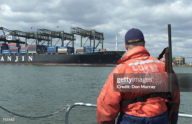 Member of the U.S. Coast Guard patrols the waters around Port Elizabeth April 1, 2002 near New Jersey. The Coast Guard and 21 other agencies are...
