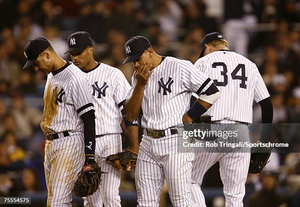 Derek Jeter, Robinson Cano and Alex Rodriguez of the New York Yankees look on dejected against the Boston Red Sox on April 27, 2006 in the Bronx...