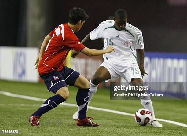 Brown Ideye of Nigeria battles for the ball with Gary Medel of Chile during the Quaterfinal match of the FIFA U-20 2007 World Cup at Olympic Stadium...