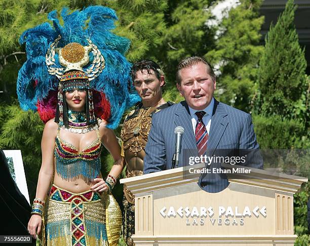 Roman characters Cleopatra and Julius Caesar look on as Caesars Palace general manager John Unwin speaks during a news conference at Caesars July 19,...