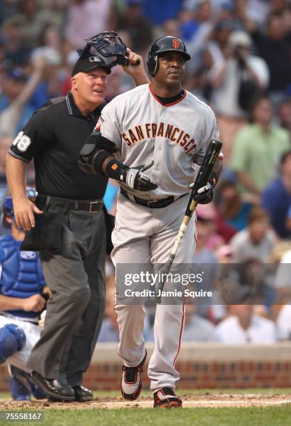 Barry Bonds of the San Francisco Giants watches the flight of the ball on his 752 career home run, in front of home plate umpire Larry Young, in the...