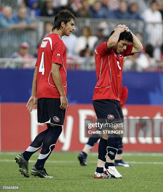 Chile's Gary Medel holds his head as he is consoled by teammate Erick Godoy following his red card in the first half of their semi-final loss to...