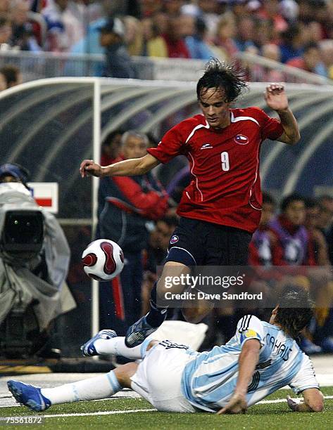 Nicolas Medina of Team Chile leaps over top of Matias Cahais of Team Argentina during their FIFA U-19 World Cup Canada 2007 semi-final game at BMO...