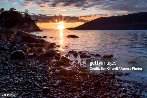 coastline with pebbles at sunset, whytecliff park, west vancouver, british columbia, canada - vancouver sunset stock pictures, royalty-free photos & images