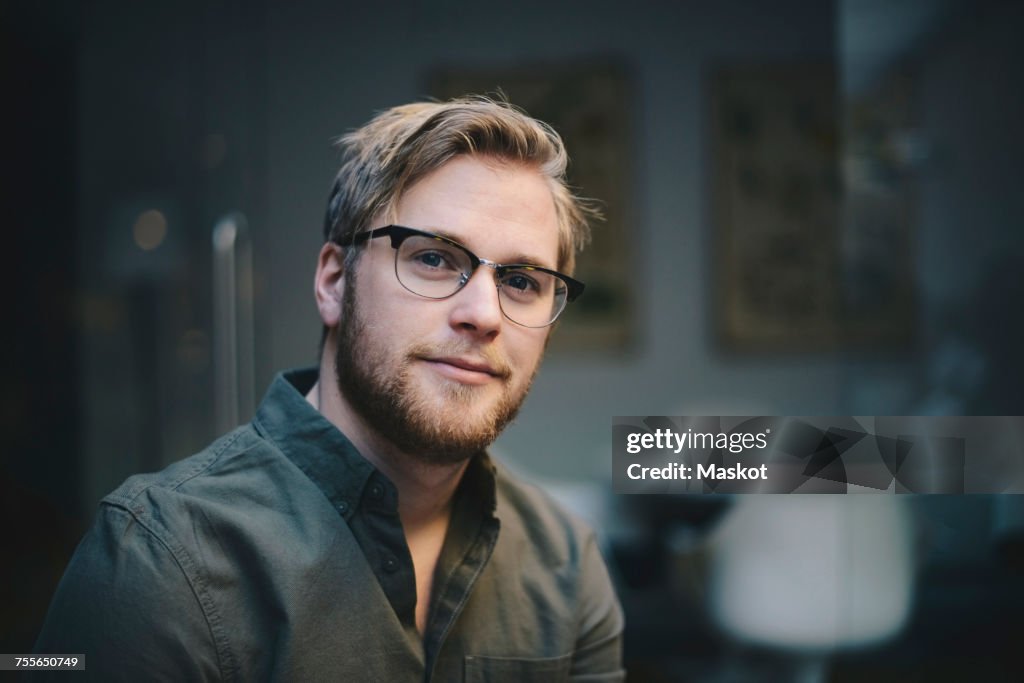 Portrait of confident male computer programmer in office