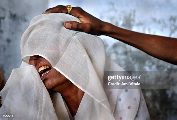 Shaikh Kulsumbibi a Muslim whose village of Sardarpur was destroyed in a gruesome vengeance attack by Hindus, weeps March 3, 2002 as she seeks refuge...