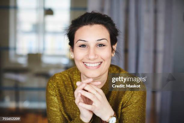 portrait of smiling businesswoman at creative office - arab man smiling stock-fotos und bilder