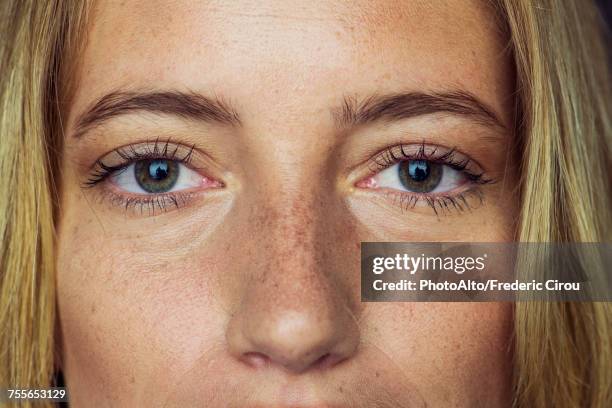 close-up of young womans face and eyes - close up woman eyes stock-fotos und bilder