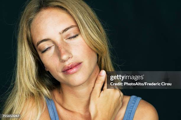 woman massaging her neck - neck pain stock-fotos und bilder