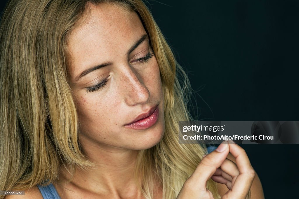 Young woman preparing to take pill