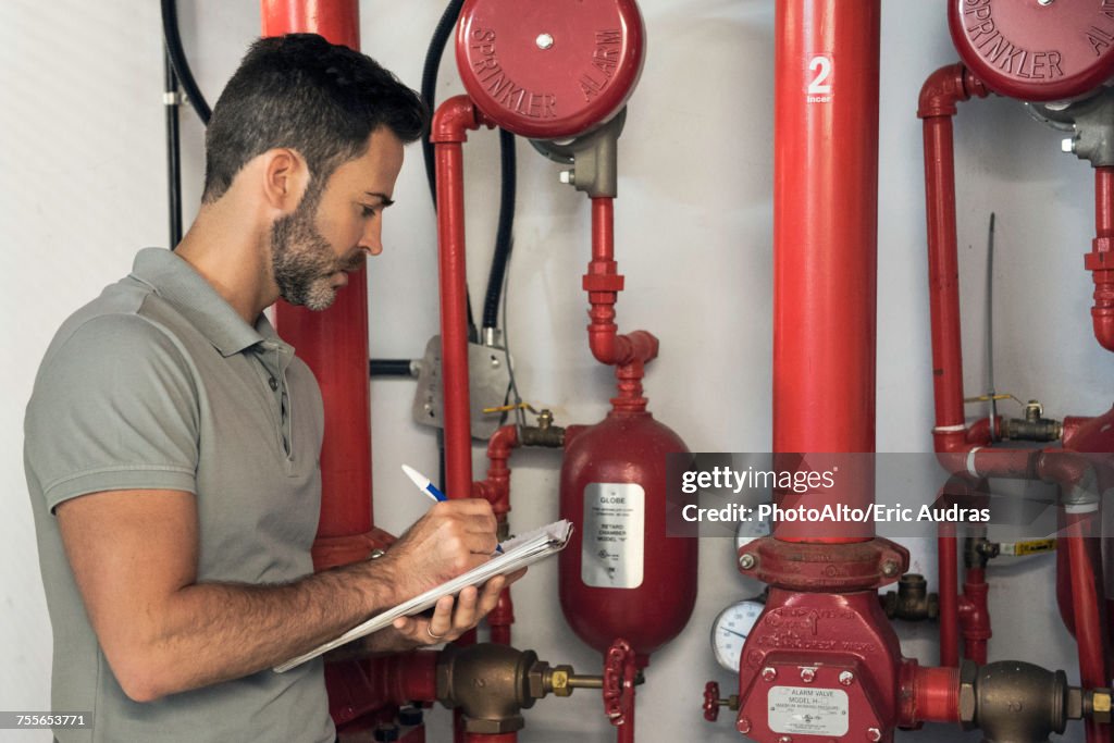 Man inspecting fire protection sprinkler system