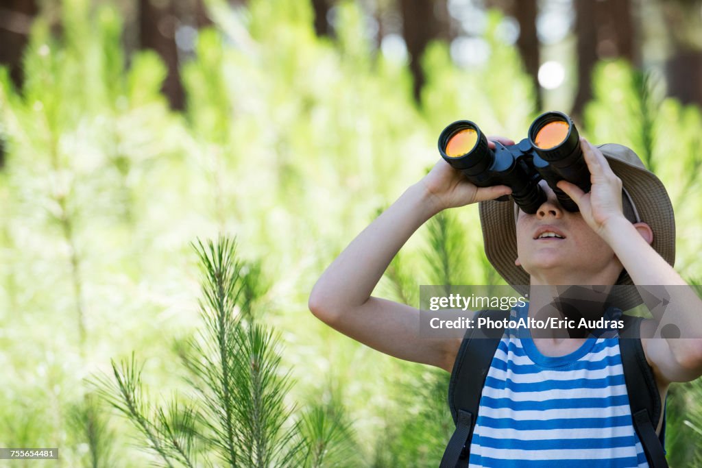 Boy looking through binoculars