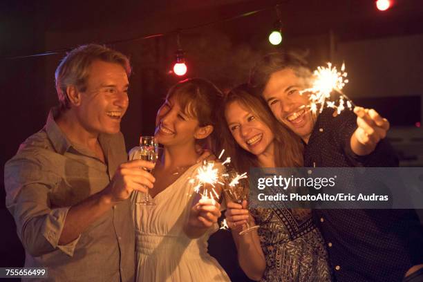 friends celebrating with sparklers and champagne - happy new year 2016 stock pictures, royalty-free photos & images