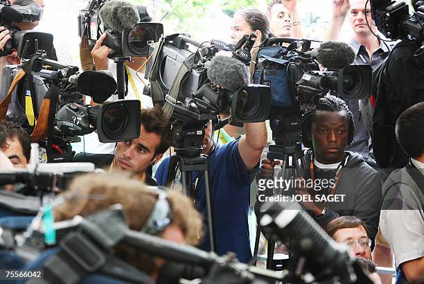 Cameramen attend a press conference given by Tour de France director Christian Prudhomme before the start of the 12th stage of the 94th Tour de...