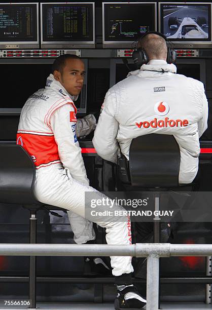 Nuerburgring, GERMANY: British McLaren-Mercedes driver Lewis Hamilton sits in a telemetry booth in the pits of the Nuerburgring racetrack, 20 July...