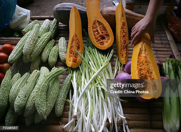 Customer shops for vegetables at a market July 20, 2007 in Chongqing Municipality, China. The Chinese economy rose by 11.5 percent in the first half...