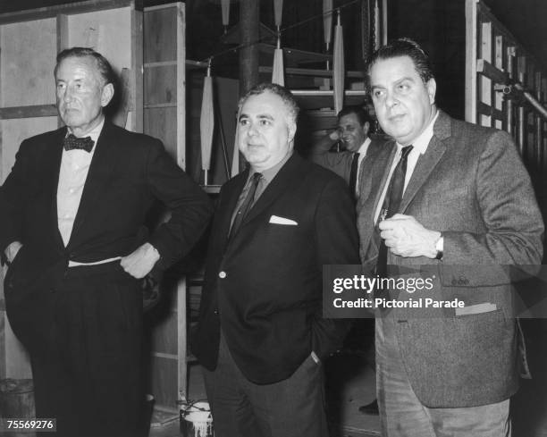 British author and creator of James Bond Ian Fleming with co-producers Harry Saltzman and Albert R. 'Cubby' Broccoli on the set of 'Goldfinger',...