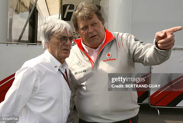 Nuerburgring, GERMANY: President of the Formula One Administration British Bernie Ecclestone chats with McLaren-Mercedez Director Norbert Haug in the...