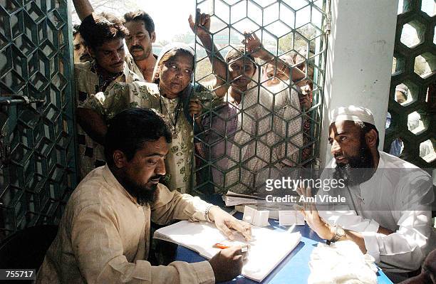 Muslims who fled their neighborhoods after their homes were torched by mobs of Hindus register at a mosque March 5, 2002 in central Ahmadabad, India....