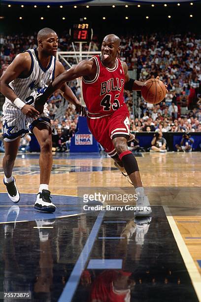 Michael Jordan of the Chicago Bulls drives to the basket against Nick Anderson of the Orlando Magic in Game One of the 1995 Easter Conference...