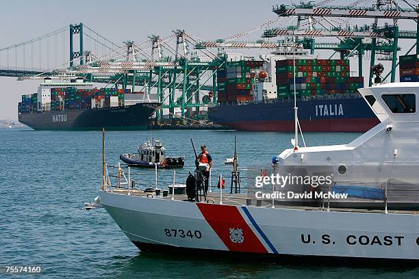 Coast Guard vessel patrols the harbor as U.S. Homeland Security Secretary Michael Chertoff attends a portside press conference during Chertoff's...