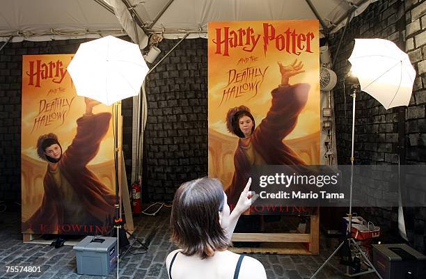 Harry Potter fans pose for a photographer while visiting "Harry Potter Place" at Scholastic headquarters before the final book goes on sale tonight...