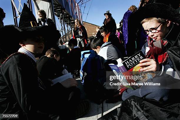 Harry Potter fans rush to read the opening lines of the new and final novel by author J.K. Rowling, "Harry Potter and the Deathly Hallows" during a...