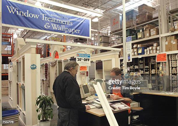 Sales associate Bruce Heggeland, right, assists a customer at a Home Depot store March 4, 2002 in Mount Prospect, IL. Home Depot Inc. Posted a 53...
