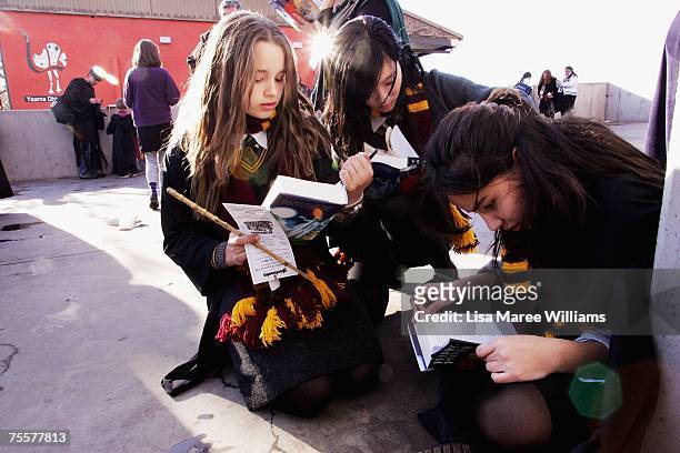 Harry Potter fans rush to read the opening lines of the new and final novel by author J.K. Rowling, "Harry Potter and the Deathly Hallows" during a...