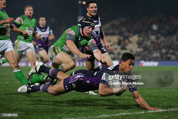 Israel Folau of the Storm dives to score during the round 19 NRL match between the Melbourne Storm and the Canberra Raiders at Olympic Park July 21,...