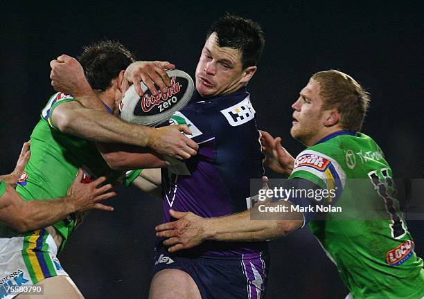 Ben Cross of the Storm takes on his old team during the round 19 NRL match between the Melbourne Storm and the Canberra Raiders at Olympic Park July...